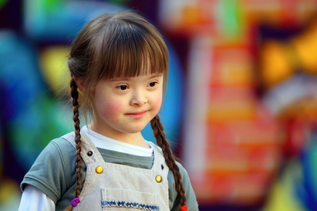 Little girl preschool aged girl with Down's Syndrome wearing her hair in plaits.