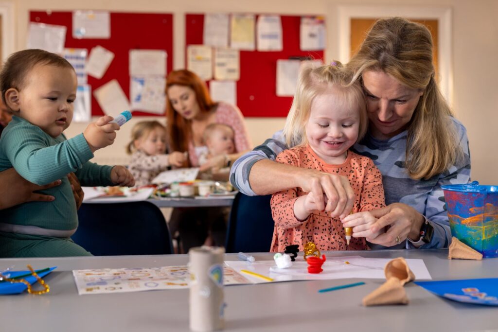 A classroom with women and children craft making